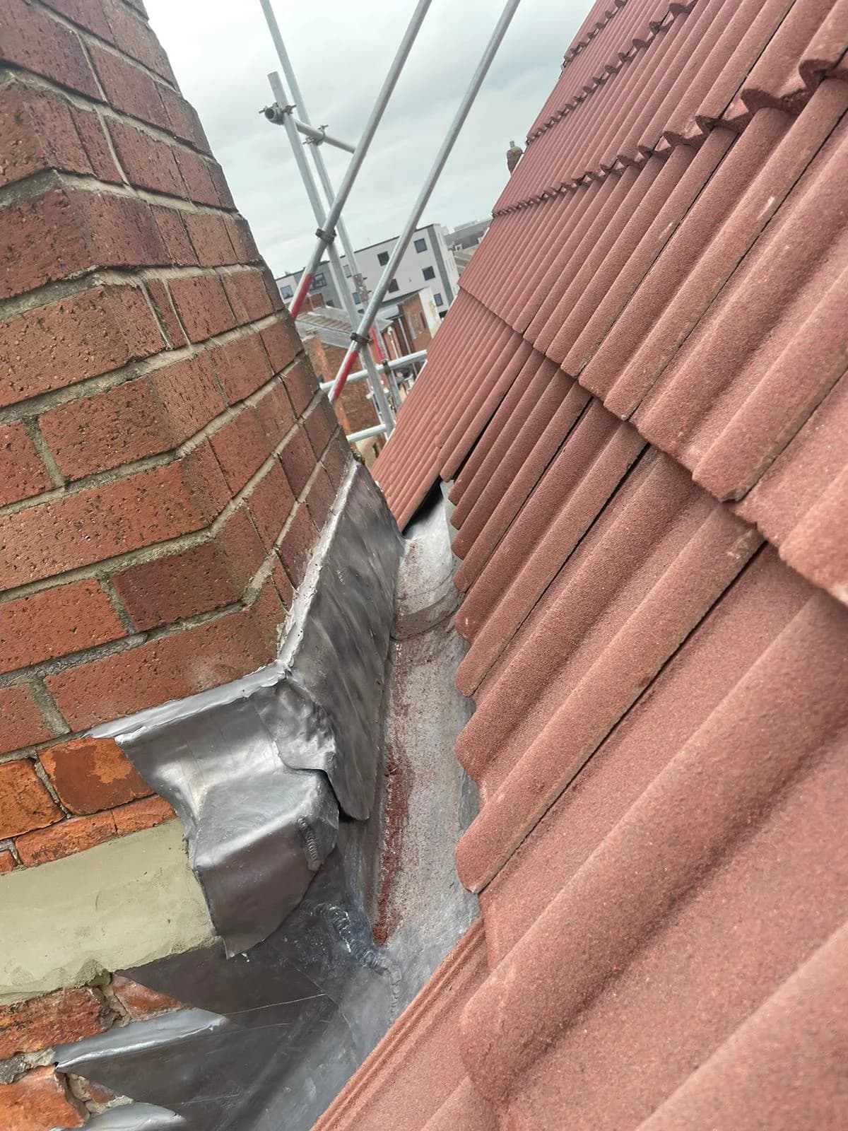 Completed natural slate pitched roof catching low sunlight in North Yorkshire